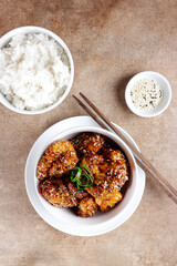 Ayam goreng Korea or Yangnyeom chicken is a fried chicken with Korean sauce with sesame seed, served with rice.