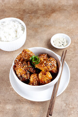 Ayam goreng Korea or Yangnyeom chicken is a fried chicken with Korean sauce with sesame seed, served with rice.