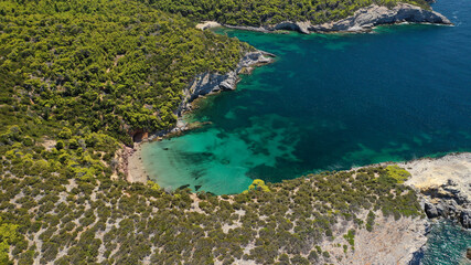 Aerial drone photo of tropical exotic paradise bay with deep turquoise sea and caves forming a blue lagoon visited by luxury yachts and sail boats