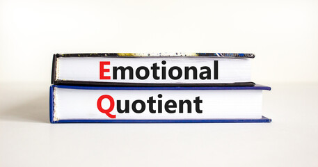 EQ emotional quotient symbol. Concept words 'EQ emotional quotient' on books on a beautiful white table, white background. Business, EQ emotional quotient concept, copy space.
