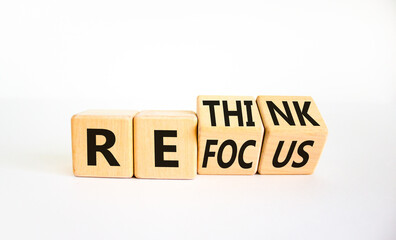 Refocus and rethink symbol. Businessman turned cubes and changed the word 'refocus' to 'rethink'....