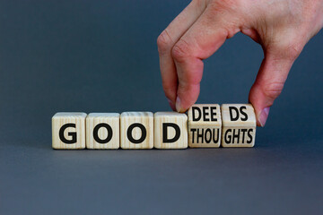 Good thoughts and deeds symbol. Businessman turns wooden cubes and changes words 'good thoughts' to...