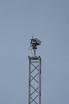 a security camera on a mast in an industry area