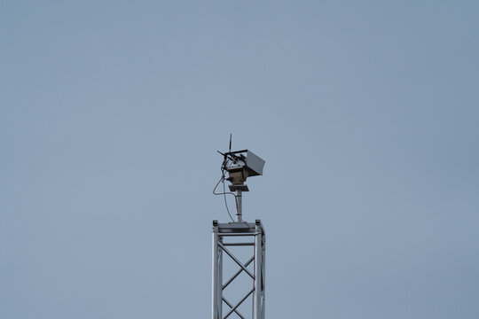 a security camera in a tower in an industry area