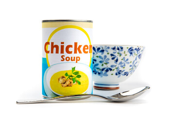 A fake generic labelled food can of chicken soup with a soup bowl and spoon isolated on white
