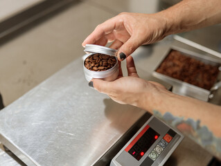 Male hands holding metal container with coffee beans