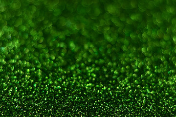 Green sparkling glitter bokeh background, christmas abstract defocused texture. Holiday lights