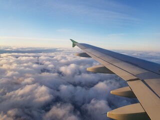 Plane wing in the blue sky