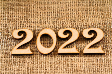 Happy New Year. The number 2022 on brown background.