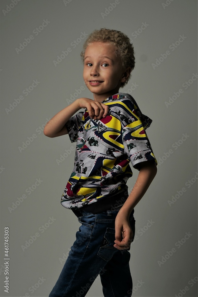 Wall mural young boy standing in studio in colorful clothes