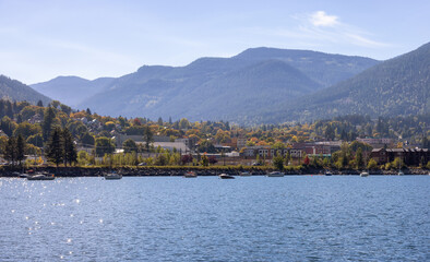 Fototapeta premium Scenic View of Kootenay River and a small touristic town. Sunny Fall Season Morning. Located in Nelson, British Columbia, Canada.