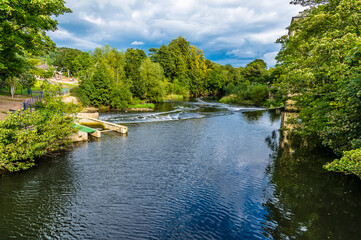 A view down the River Aire on the outskirts of the model village of Saltaire, Yorkshire, UK in...