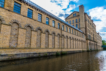 Fototapeta premium A view down an old mill building in the model village of Saltaire, Yorkshire, UK in summertime