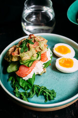 Belgian waffles with salmon, cucumber and egg in a plate