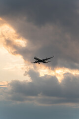 Fototapeta na wymiar Commercial airliner flying just below the clouds