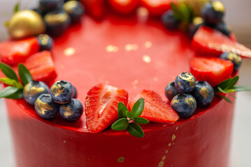 Red cake with cream cheese frosting for a big event. luxurious cake with golden decoration and berries on top on the white background © alexanderon