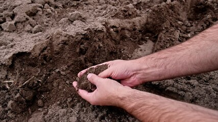 Cacuasian Male Touching and Grabbing Dry Brown Fertile Soil With Bare Hands - Powered by Adobe