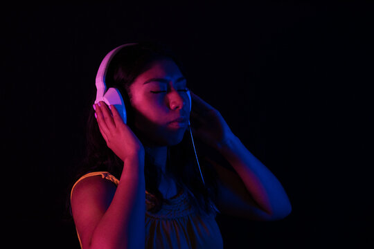Girl listening to relaxing music with headphones