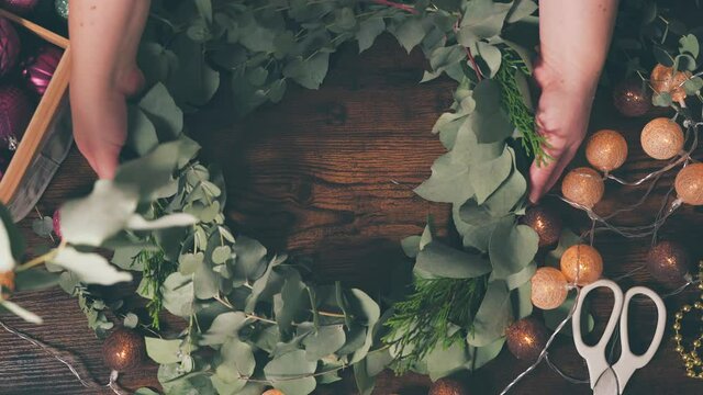 Handmade christmas wreath on dark table. Top view. DIY and handcraft concept for holidays. 4K UHD