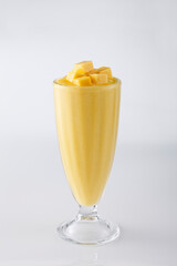 Fresh mango smoothie isolated on white background.