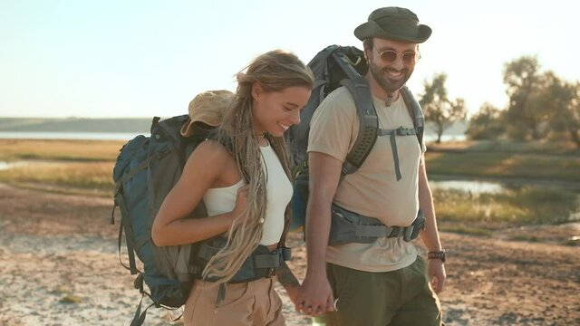 Smiling tourist couple walking in nature