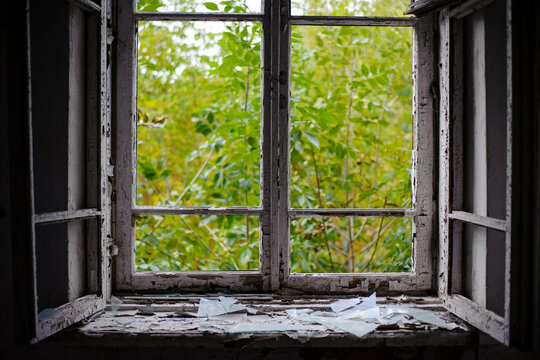open window with old wooden frame. old window. finely broken glass. old house, retro. cracked window frame. cracked old paint, pieces of glass. space for text. large pieces of glass. close-up