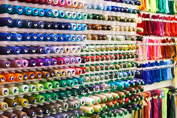 Fototapeta na wymiar Bobbins with colored thread for industrial textile