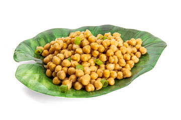 A  fancy green plate of canned chick peas garnished with green onion slices isolated on white
