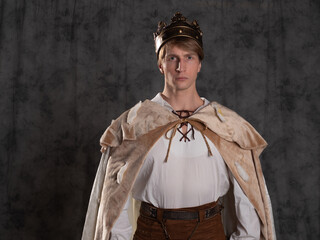 The young king. A noble young man in a fantasy historical costume,