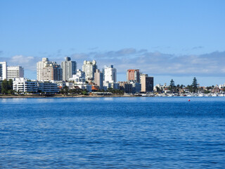 Fototapeta premium View of the ocean and the coast in Punta del Este, Uruguay. Tall buildings in front of the sea and boats on the shore.