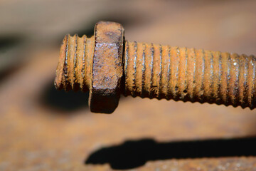 old rusty bolt, iron rod with screw threads. Rusted mechanical components. threaded bolt and nut isolated close up. dismantling concept, difficult to unscrew, non-removable. selective focus