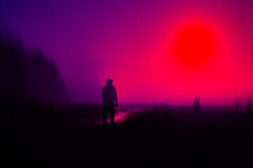 A spooky concept. Of a hooded figure silhouetted against the moon in the countryside at night. With a neon vapor wave edit