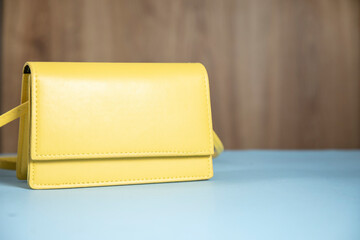 fashion yellow handbag on blue table