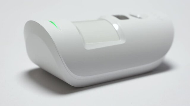 Indoor security system equipment, smart motion detection, wireless motion detector on the wall sends an alarm signal to security company. High quality 4k footage