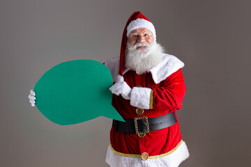 Santa Claus holding blank text balloon.