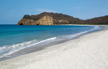 Long Shot of  a beautiful beach and sea on a sunny day at Ecuador.