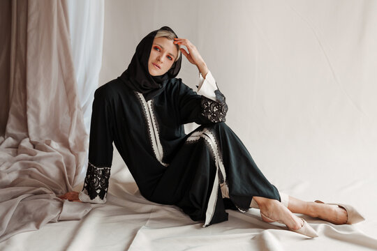 Beautiful Muslim Woman In Traditional Arabian Abaya Dress On Gray Background