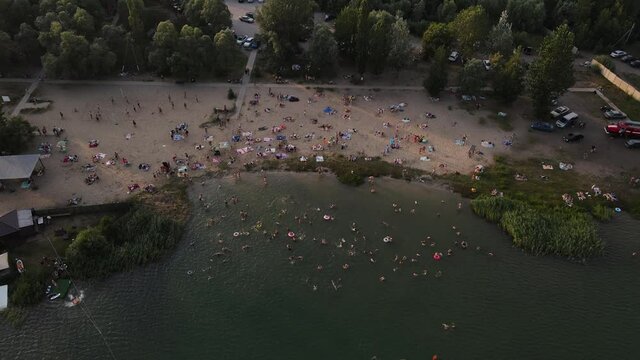 4K footage of a sandy beach from a drone filled with people