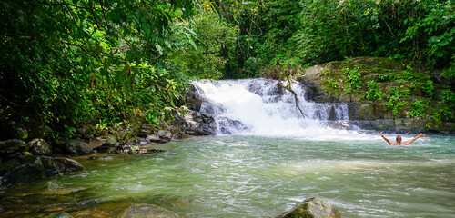 Woman bathing in a river by a waterfall. Costa Rica - 461771549