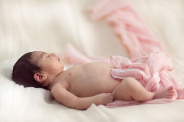 Fototapeta na wymiar Newborn baby sleeping on the bed. Horisontal oroentation.