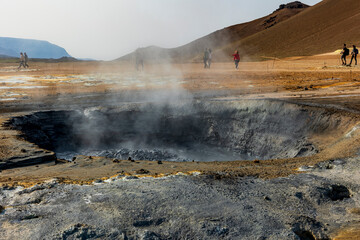 surreal landscape in   geothermal area near Lake Myvatn, Iceland.  Hverir is characterized by boiling mud pots and fumaroles that steam. 