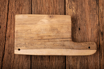 Wooden cutting board on rustic background.