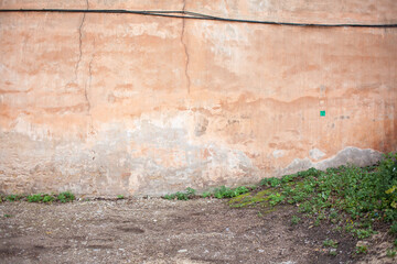 Old vintage type orange wall. Grungy look wall. Aged wall in the city.
