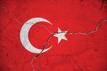An image of the flag of Turkey on a wall with a crack.