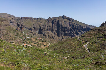 The Macizo de Teno mountains, Masca Gorge with mountain road to the village of Maska. View from the observation deck - Mirador La Cruz de Hilda. Tenerife. Canary Islands. Spain.
