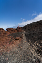 Rocky coast of the Atlantic Ocean at Cape Teno. A lighthouse in the background. Tenerife. Canary Islands. Spain.