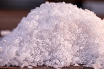 A close-up macro shot of a handful of coarse salt.