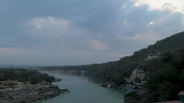 A swift sunset over the Ganges river in Rishikesh. Evening Timelapse