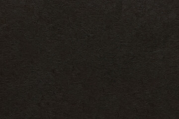 Dark non-uniform paper with spots and inclusions.