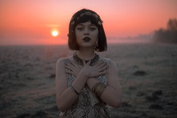 Desert in Egypt. Girl portrait in egypt style clothes. Sunset. Close-up